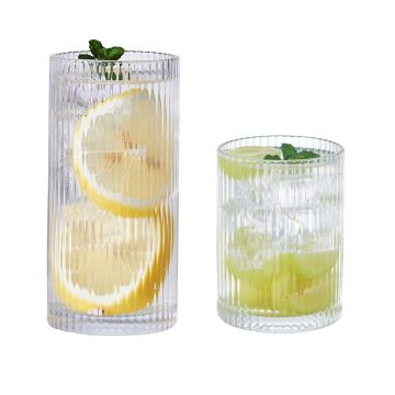 Stylish striped glass highball glasses lined up on a polished table with a soft glow illuminating their sophisticated design, perfect for upscale dining and cocktail evenings