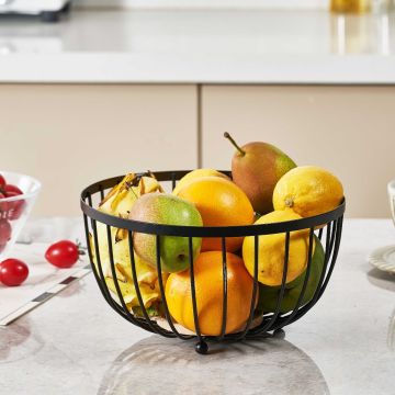 Black Round Metal Fruit Bowl with Wooden Base on a kitchen countertop